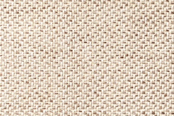 Beige vintage fabric with woven texture closeup. Textile macro background