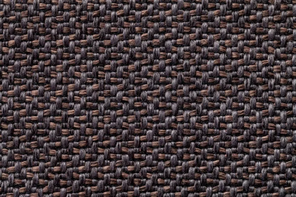 Black and brown vintage fabric with woven texture closeup. Textile macro background