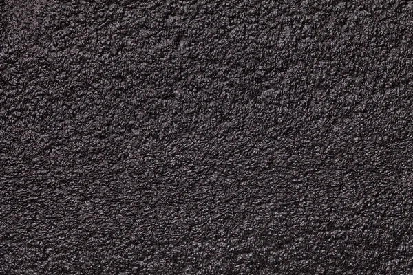 Czarne błyszczące tło zbliżenie pianki. Tekstura materiału budowlanego gumowe — Zdjęcie stockowe