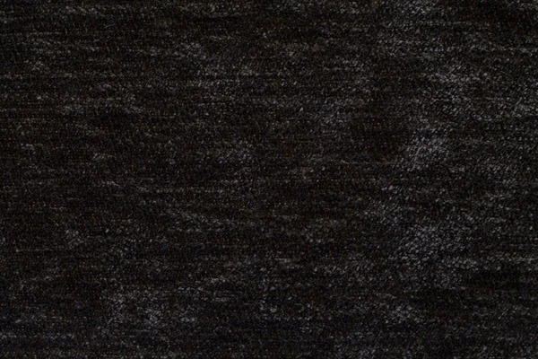 Schwarzer, flauschiger Hintergrund aus weichem, flauschigem Stoff. Textur von textilen Nahaufnahmen. — Stockfoto