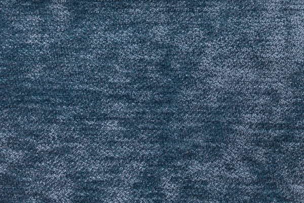 Blue fluffy background of soft, fleecy cloth. Texture of textile closeup