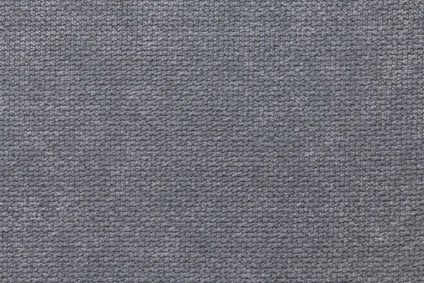 Dark gray fluffy background of soft, fleecy cloth. Texture of textile closeup