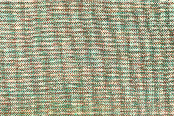 Light green and red textile background with chess pattern, closeup. Structure of the fabric macro.