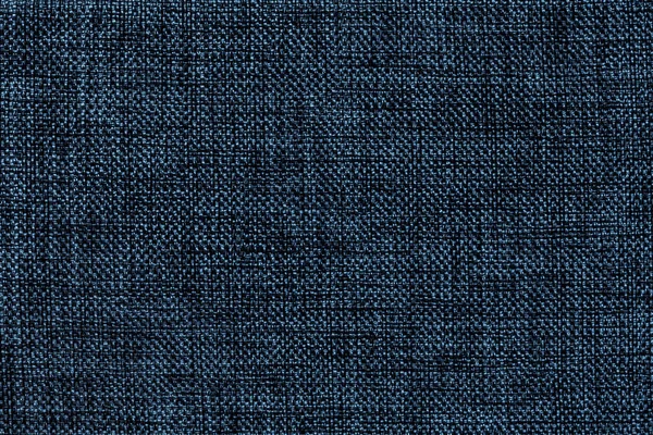 Navy blue background of dense woven bagging fabric, closeup. Structure of the textile macro.