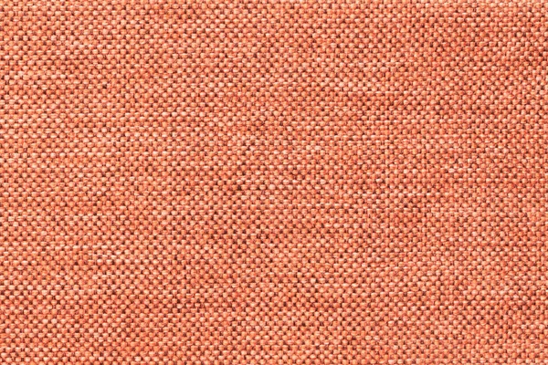 Ανοιχτό πορτοκαλί φόντο του πυκνού υφαντό ύφασμα πακεταρίσματος, κοντινό. Δομή της μακροκλωστοϋφαντουργίας. — Φωτογραφία Αρχείου