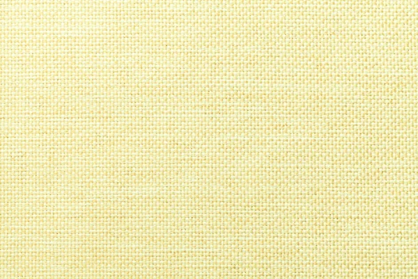 Světle žluté pozadí husté, tkané bagrovací tkaniny, těsný. Struktura textilního makra. — Stock fotografie