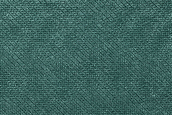 Dark green fluffy background of soft, fleecy cloth. Texture of light nappy textile, closeup.