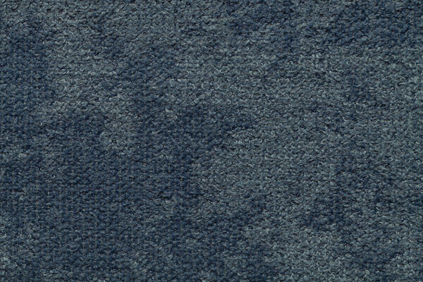 Dark blue fluffy background of soft, fleecy cloth. Texture of light nappy textile, closeup.