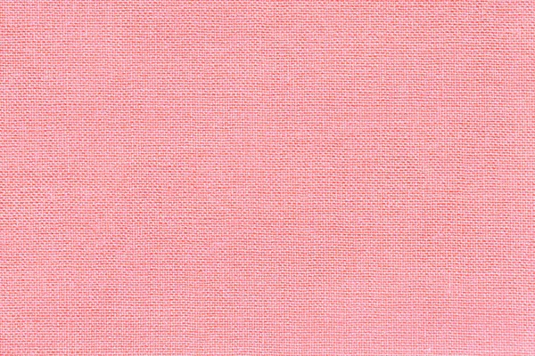 Světle růžové pozadí z textilního materiálu s proutěným vzorem, closeup. — Stock fotografie