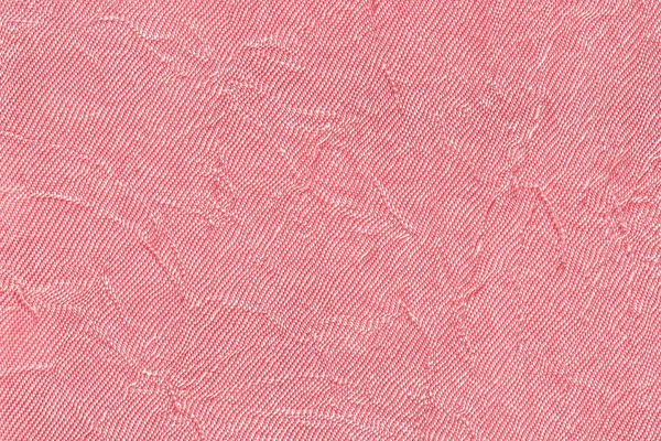 Licht roze golvende achtergrond van textiel materiaal. Stof met plooi textuur closeup. — Stockfoto