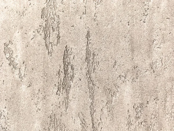 Vieux mur brun clair recouvert de plâtre irrégulier minable. Texture de la surface de pierre de bronze vintage, gros plan — Photo