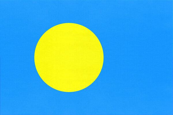 Republic of Palau national fabric flag, textile background. Symbol of world oceania country