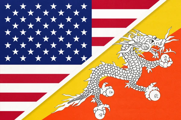 USA vs Kingdom of Bhutan national flag from textile. Relationship between two american and asian countries. — Stock Photo, Image