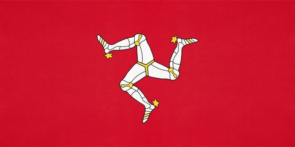 Mans nasjonale flagg, tekstilbakgrunn. Symbol for Storbritannia Internasjonalt land . – stockfoto