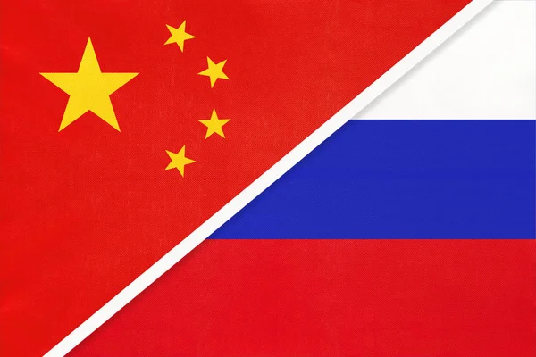 China or PRC vs Russia national flag from textile. Relationship between asian and european countries. — Stock Photo, Image