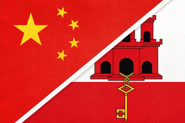 China or Prc vs Gibraltar national flag from textile Відносини між азійськими та європійськими країнами. — стокове фото