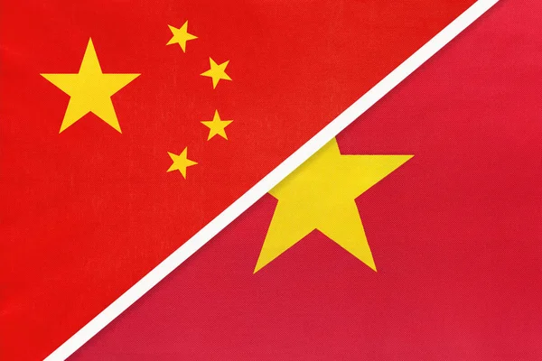 People's Republic of China or PRC vs Vietnam national flag from textile. Relationship between two asian countries. — 스톡 사진