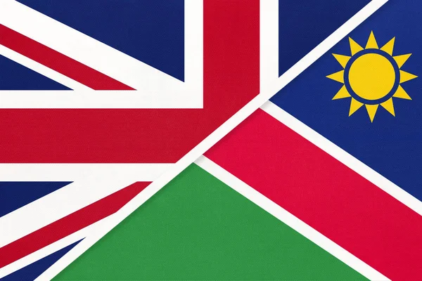 United Kingdom of Great Britain and Ireland or UK vs Republic of Namibia national flag from textile. Relationship, partnership and economic between two European and African countries.