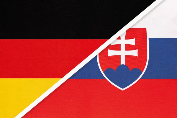 Federal Republic of Germany vs Slovakia or Slovak Republic, symbol of two national flags from textile. Relationship, partnership and economic between european countries.