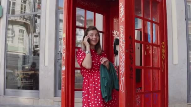 Young Woman Tourist is Talking on Mobile Phone in Telephone Box — 비디오