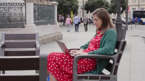 La mujer freelancer está trabajando en el ordenador portátil en City Square — Vídeos de Stock