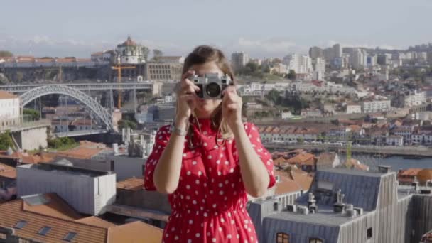 Жінка в червоній сукні робить фотографію панорамного виду — стокове відео