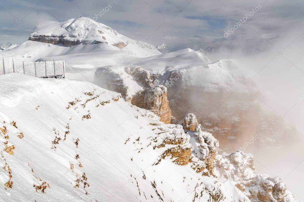 Foggy view of Dolomite Alps from viewpoint of Passo Pordoi near Canazei of Val di Fassa, Trentino-Alto-Adige region, Italy.