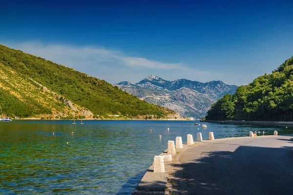 Sunny morning view of Kotor bay and coastal road near Tivat, Lun. — Foto de Stock