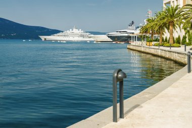 Beautiful embankment on the background of luxury yachts at the p