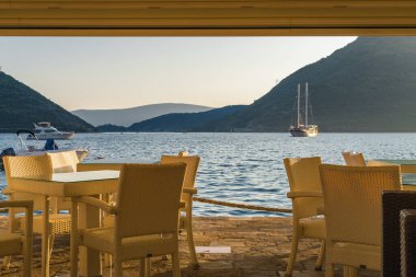 Karadağ 'ın güzel Perast kentinden Kotor Körfezi' nin arka planında günbatımı manzaralı geçiş.