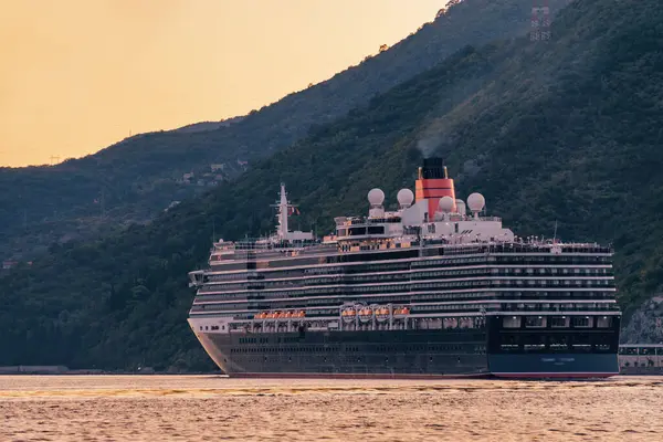 Sunset view of cruise liner an the background of Kotor bay from beautiful town Perast, Montenegro.