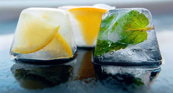 Частини лимонаду шматочки льоду з лимоном, м'ятою, апельсином . — стокове фото
