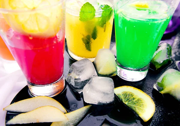 Erilaisia tuoreita limonadeja laseissa kevyellä taustalla — kuvapankkivalokuva