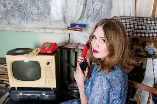 portrait of beautiful blonde woman with retro telephone in soviet union interiour