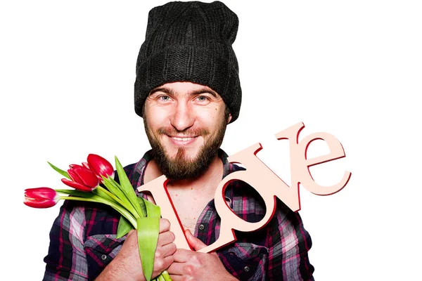 Fiatal csípő férfi fekete kalapot fehér tulipán és a névtábla szerelem — Stock Fotó