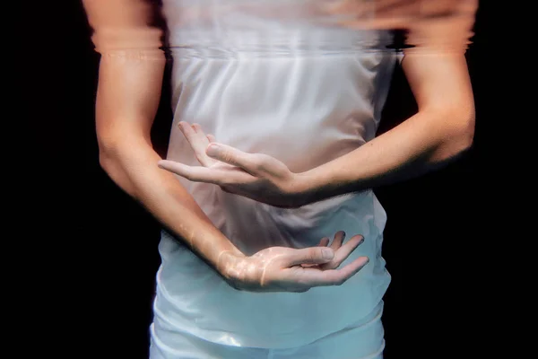 Dancing hands underwater on black background in the swimming pool — Stock Photo, Image