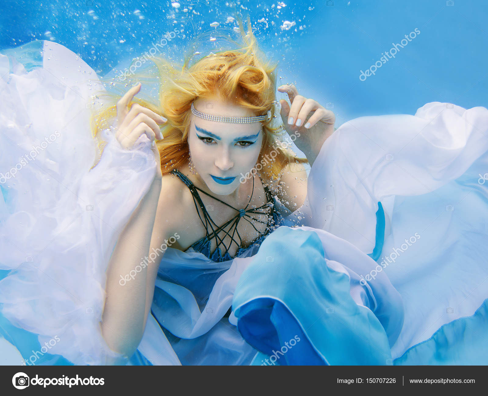 Underwater fashion portrait of beautiful blonde young woman