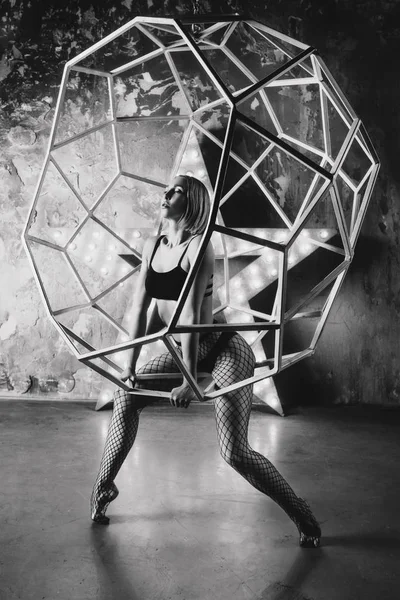 portrait of beautiful attractive blonde woman dancer with huge star on the background  in the loft dance studio