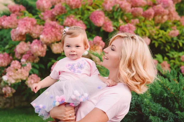 Mutlu genç gülümseyen anne parkta bebeğini açık ile