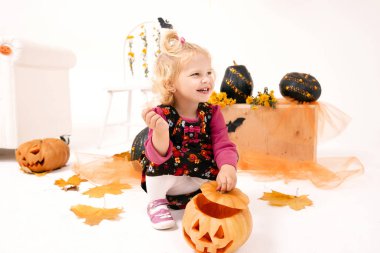 komik ve sevimli küçük sarışın eğrisi kız pumking Cadılar Bayramı dekorasyonu ile