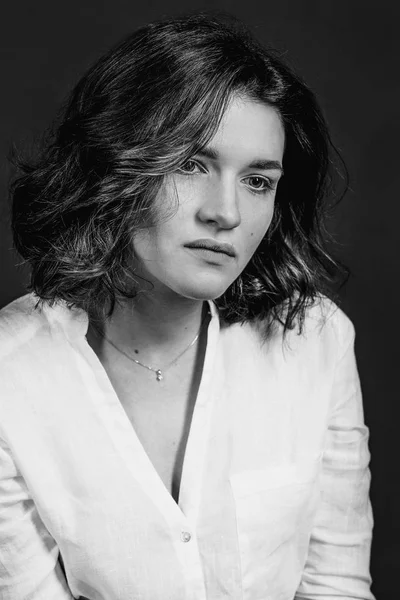 Genç, güzel bir üzgün kadın oyuncu stüdyoda kısa kahverengi saçlı, siyah ve beyaz portraite