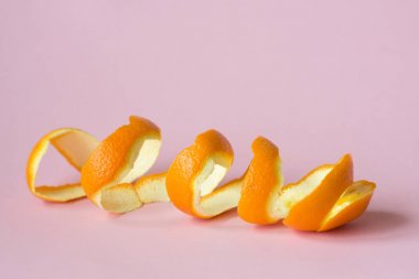 orange peel on pink background as a symbol of recycling circulate economy clipart