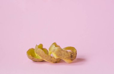 potato peel on pink background as a symbol of recycling circulate economy clipart
