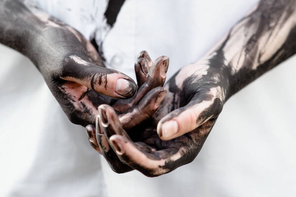 Dirty hands with black gold - oil. Pollution, eco, eco guilt, global warming, recycling concept