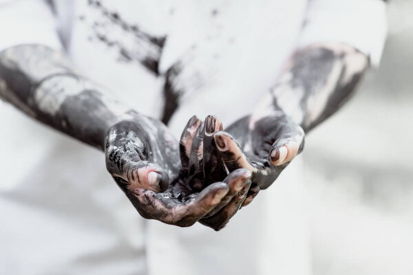 Dirty hands with black gold - oil. Pollution, eco, eco guilt, global warming, recycling concept