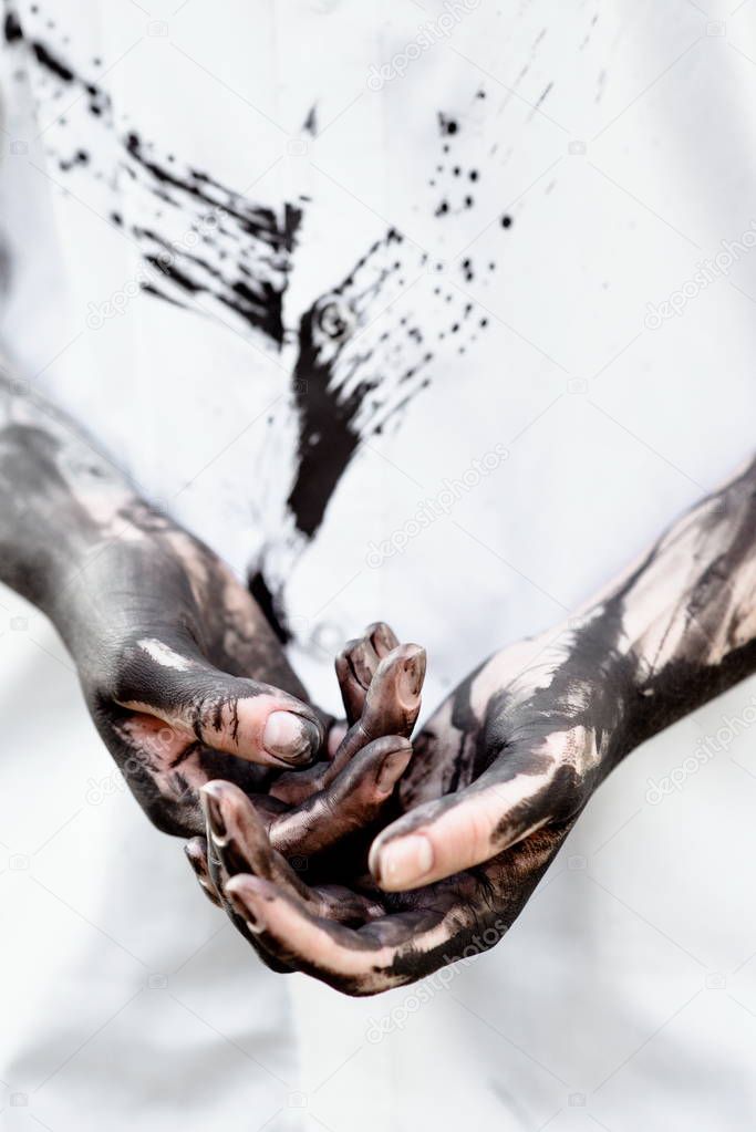 Dirty hands (body parts) with black gold - oil
