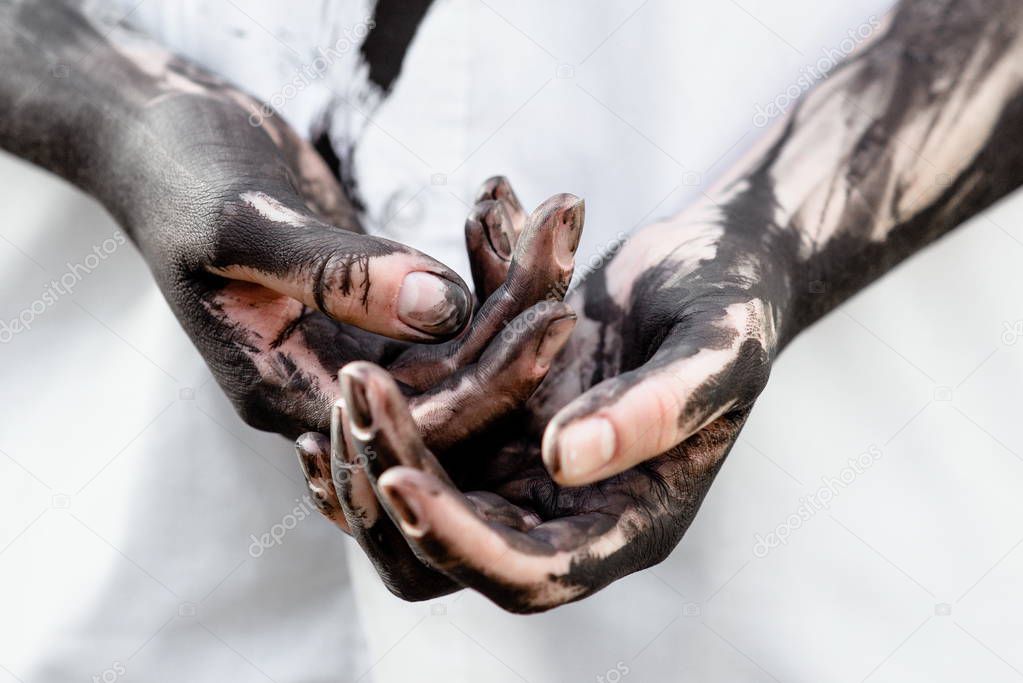 Dirty hands with black gold - oil. Pollution, eco, eco guilt, global warming, recycling concept