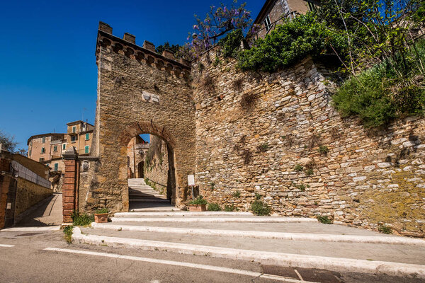 SERRE di RAPOLANO, TUSCANY, Italy - April 25, 2018: trekking in Serre di Rapolano known for the travertine quarries, but from the medieval heart, Siena. Medieval town entrance