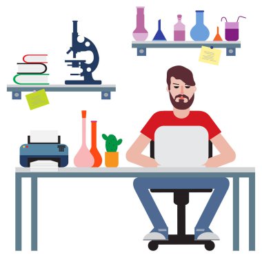 Masada oturan ve dizüstü bilgisayarda çalışan adam.