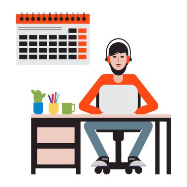 Masada oturan ve dizüstü bilgisayarda çalışan adam.